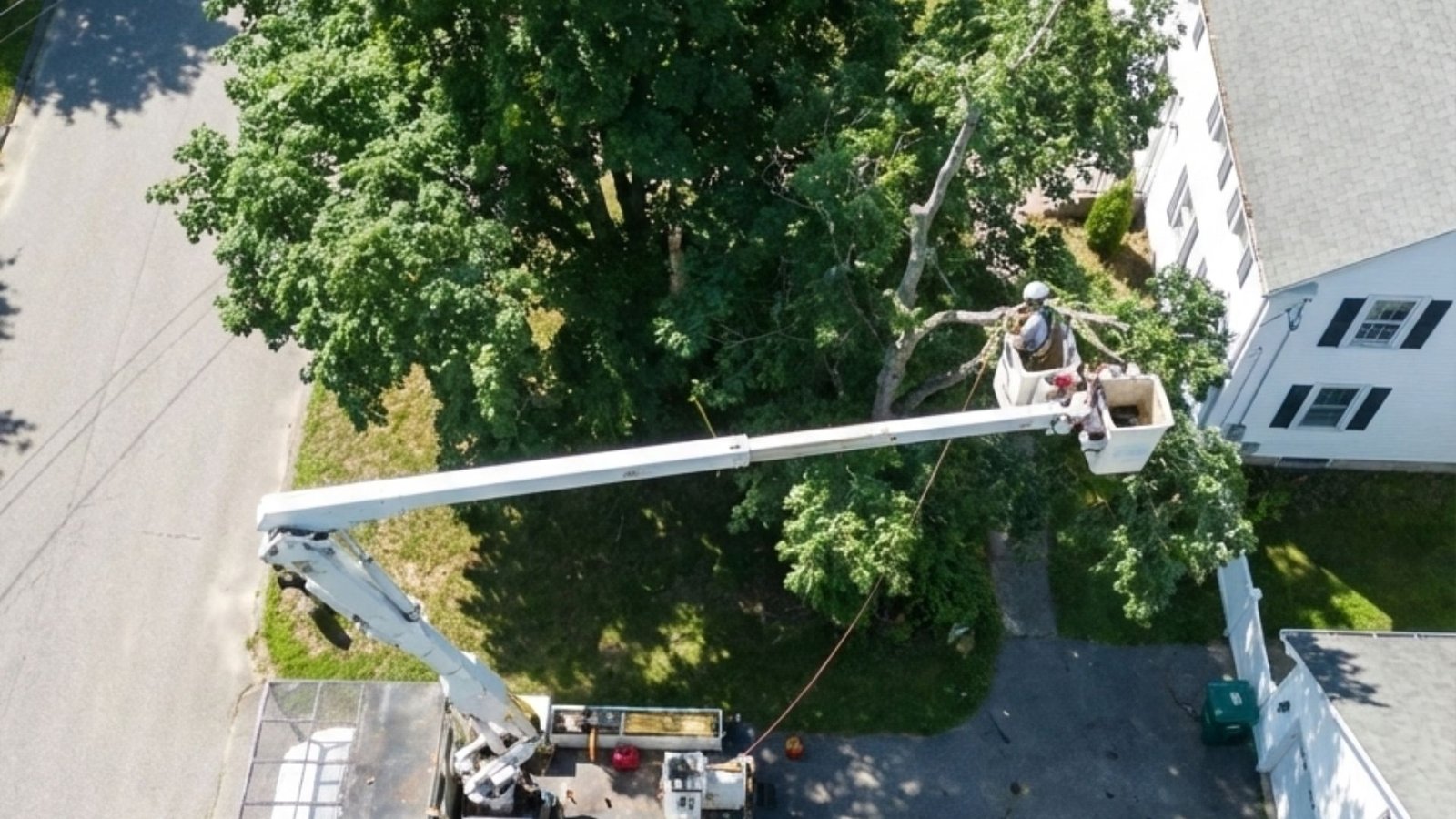 Drone View of Tree Removal Bucket Truck Operating Near Home in Monroe Connecticut