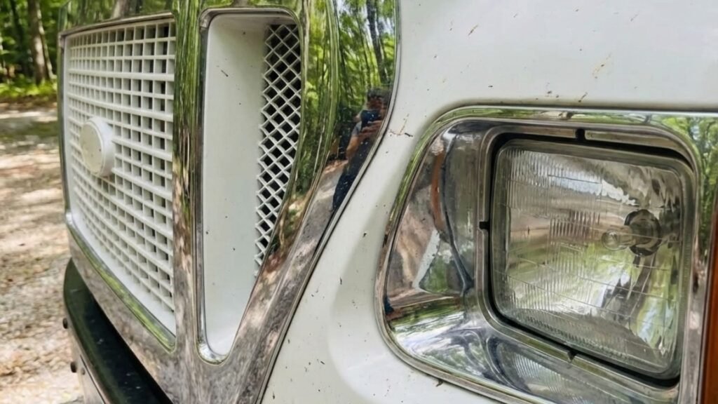 Close-up of tree removal service truck grille and headlight at a wooded residential site in Woodbury Connecticut