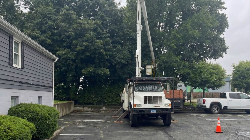Bucket Truck Positioned for Connecticut Tree Removal in Parking Lot
