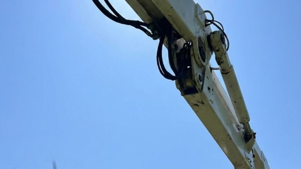Low angle view of bucket truck boom extended for residential tree removal in Woodbridge Connecticut