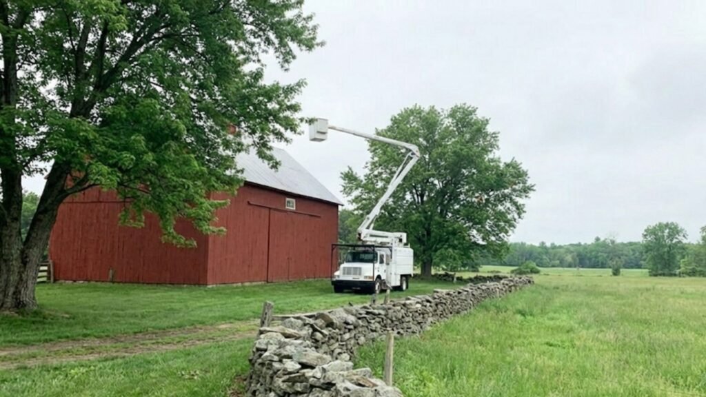 Bucket Truck Positioned for Tree Work Near You on Open Property in Oxford Connecticut