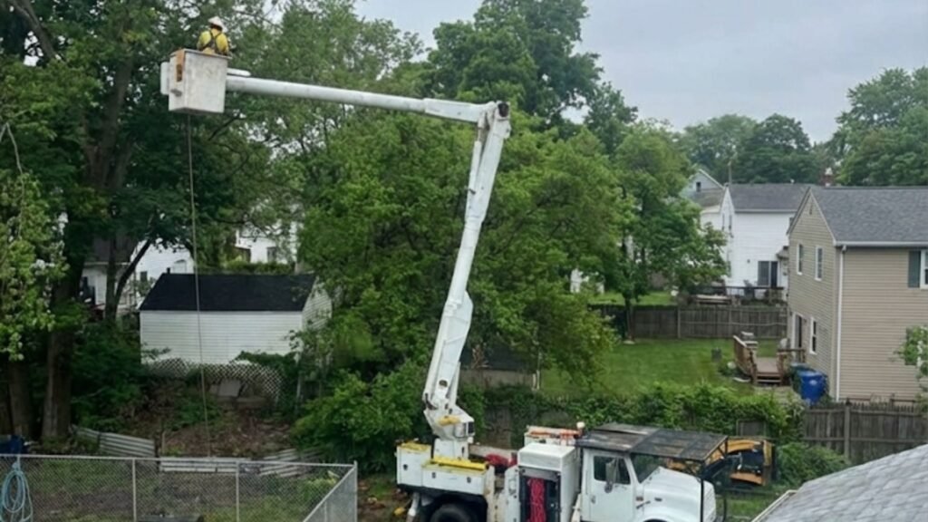 Bucket truck tree service working behind homes in Bridgewater Connecticut