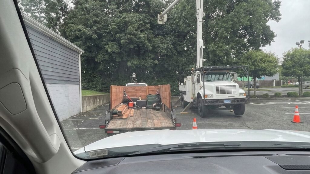 View From Truck of Bucket Truck and Trailer During Connecticut Tree Removal