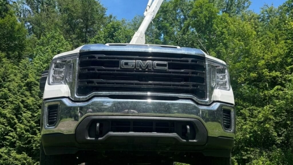 Bucket truck positioned on residential property for tree removal work in Woodbridge Connecticut