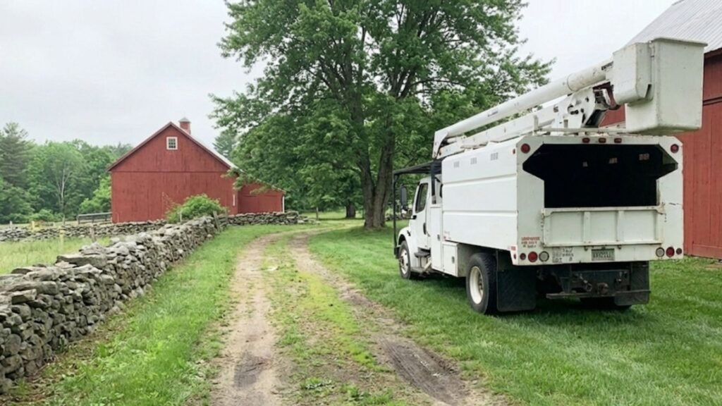 Bucket Truck Positioned for Tree Work Near Me Along Farm Drive in Oxford